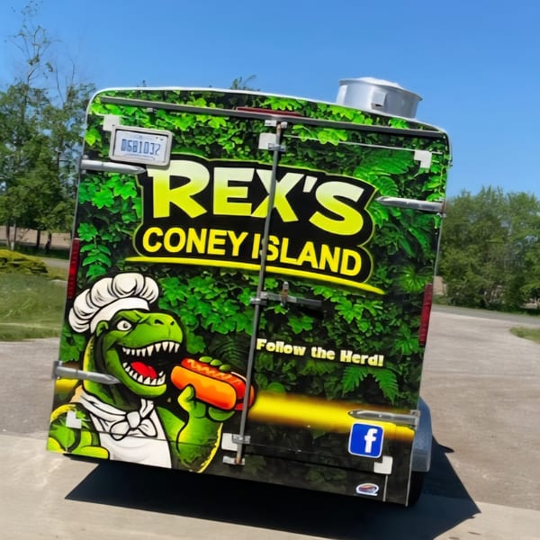Rex's Coney Island food truck with a chef dinosaur holding a hot dog, against a blue sky.